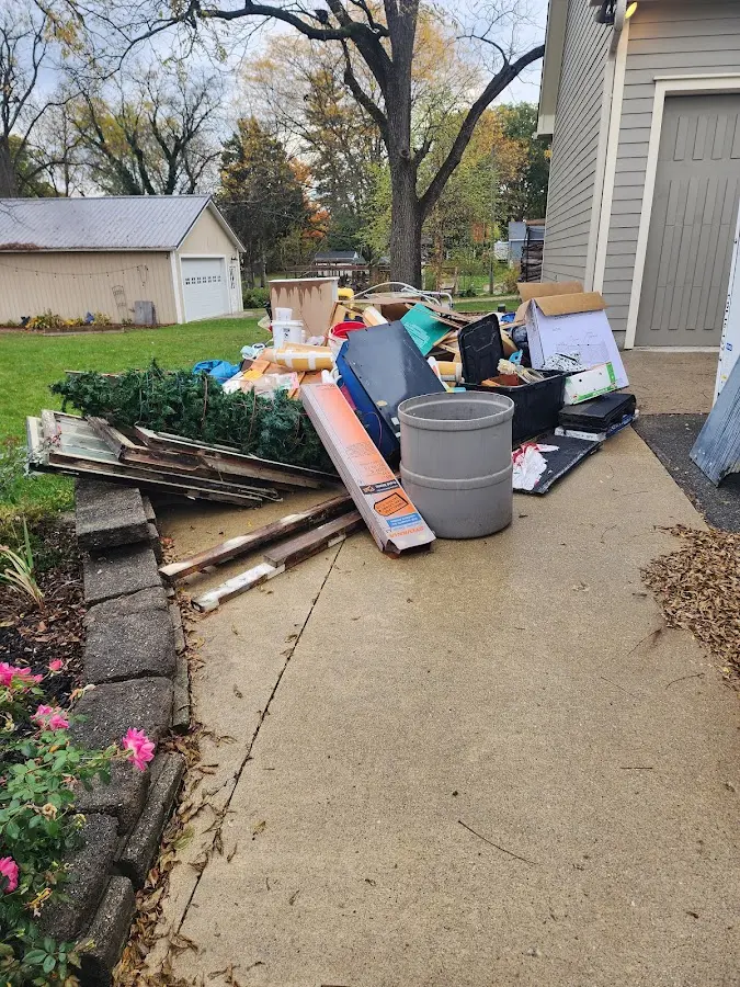 Dumpster being loaded with debris for Estate Cleanout Dumpster Rental in Four Corners